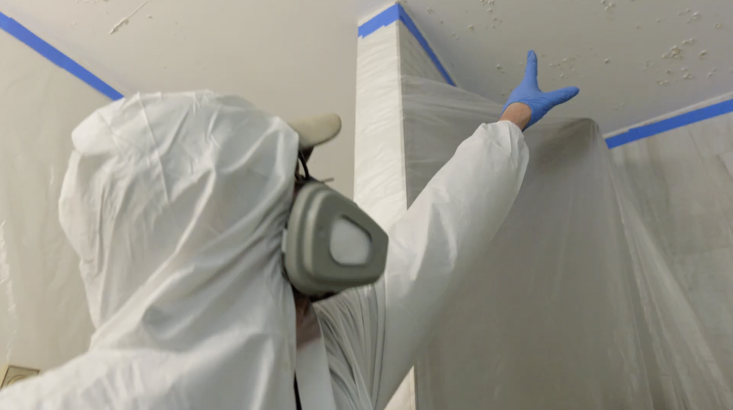 Mold Remediator Pointing to Signs of Mold - Mold Men NJ Mold Remediator in White Township, NJ in Full PPE Pointing To Signs of Mold