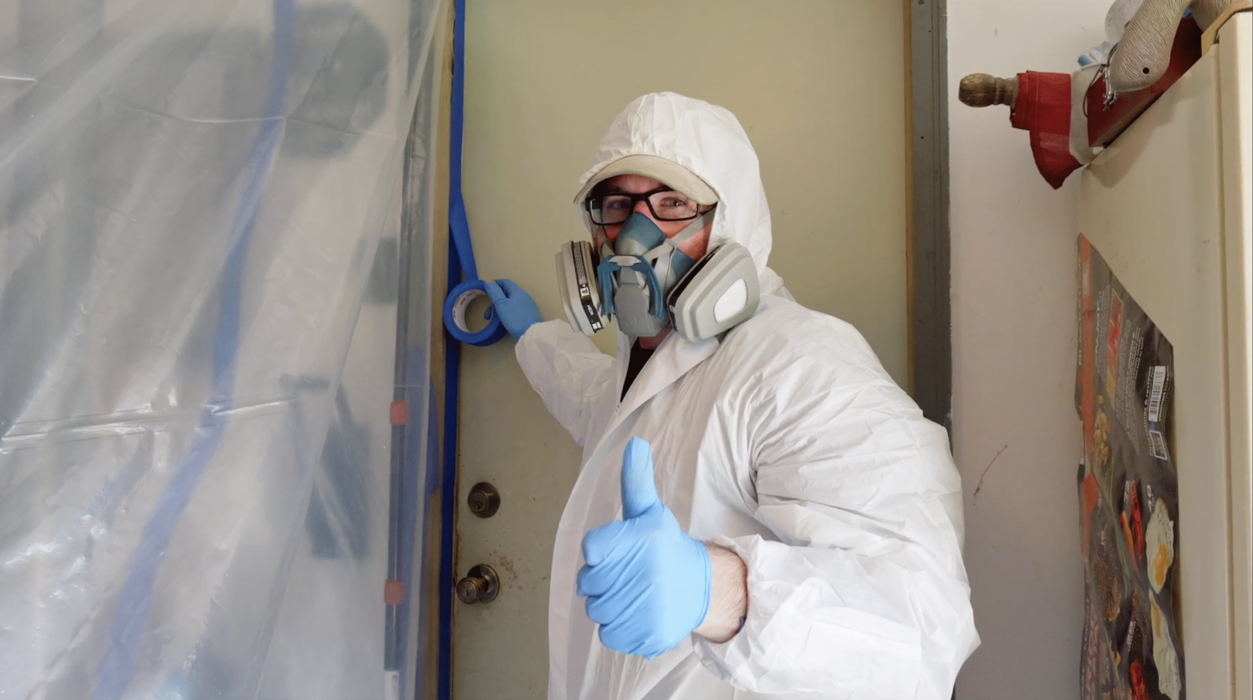 Mold Remediator Thumbs Up Certified mold remediation tech in Morris County, NJ wearing full PPE Thumbs Up in Front of Containment area.