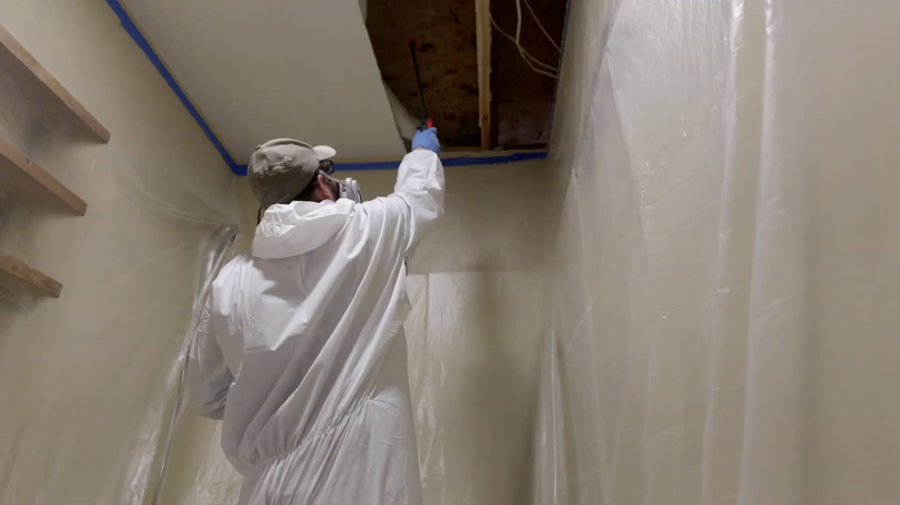Spraying for Mold - Mold Men NJ Mold Clean up in Ogdensburg, NJ Certified mold remediation tech in PPE spraying for mold.